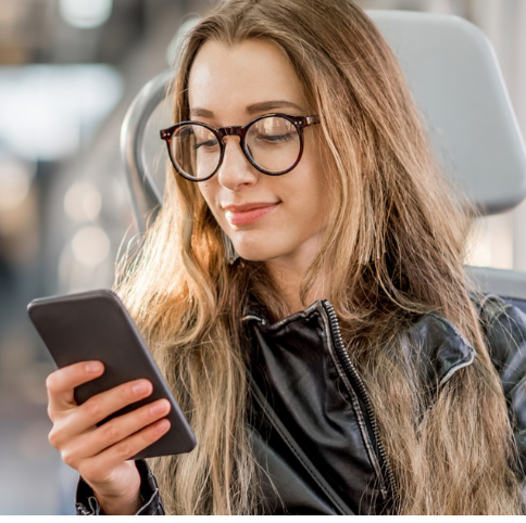 Dwellworks Living - Solutions for Global Corporate Relocation - Woman on Train on Phone